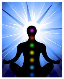 male silhouette meditating with chakra