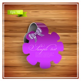 violet flower ribbon badge on wood background